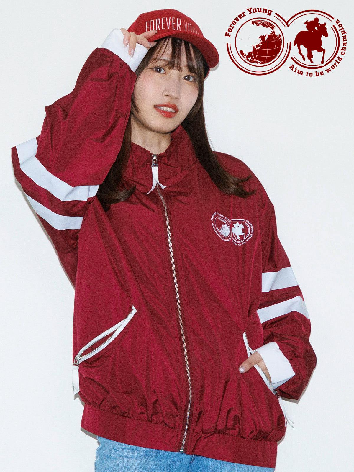 A model wearing a red polyester blouson with white sleeve stripes, a front zipper, and a chest logo.