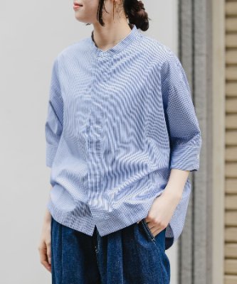 Model wearing a blue striped FORK&SPOON cocoon short-sleeve women's cotton shirt, shown from the front and slightly turned.