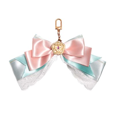 A pastel pink and mint ribbon bow bag charm with lace trim, a gold clasp, and a central decorative emblem.
