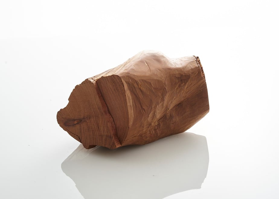 A piece of incense wood (香木) shown on a white reflective surface.
