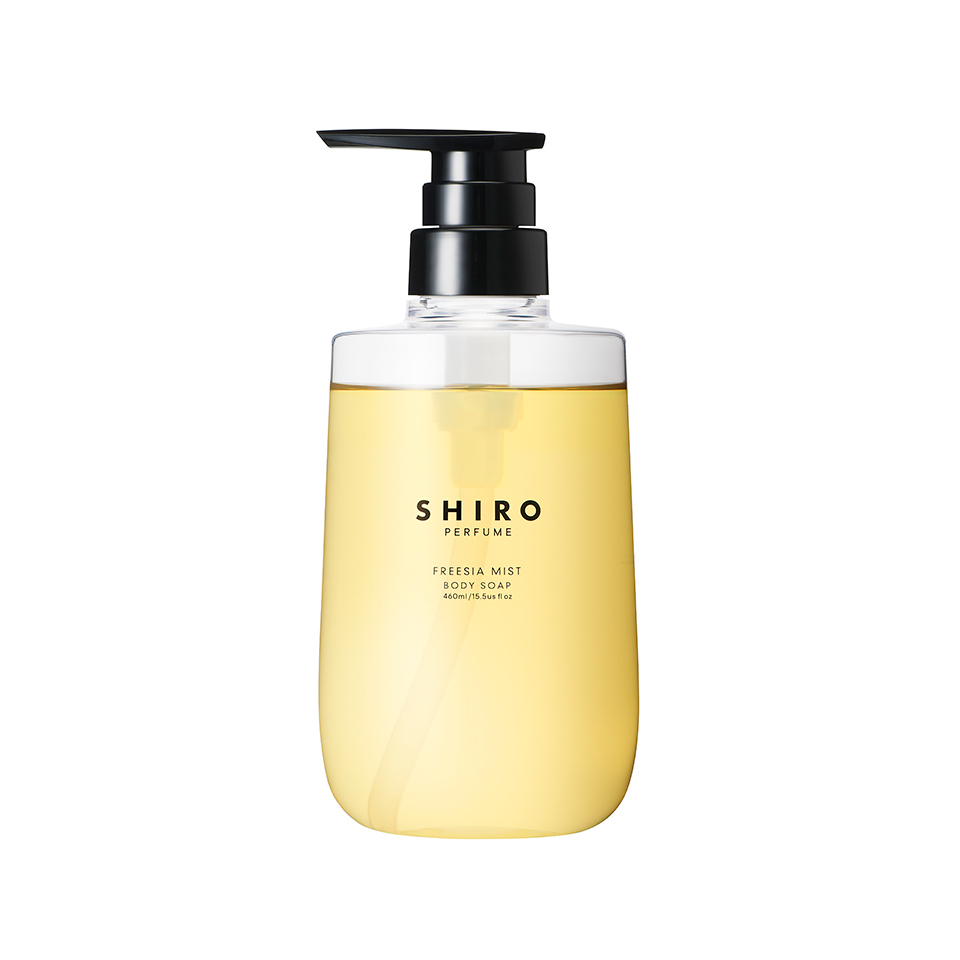 Clear pump bottle of FREESIA MIST body soap showing pale yellow liquid and SHIRO label.