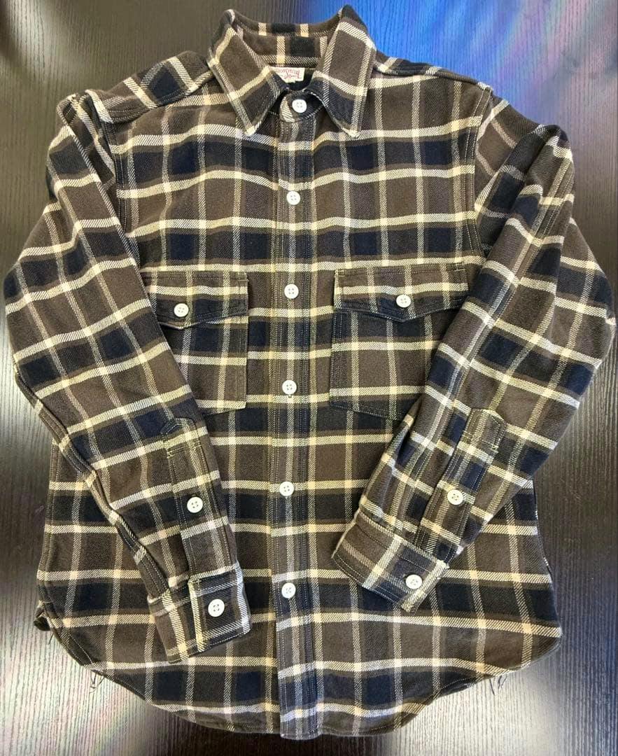 Men's cotton flannel shirt laid flat showing the front with button closure and two chest pockets.