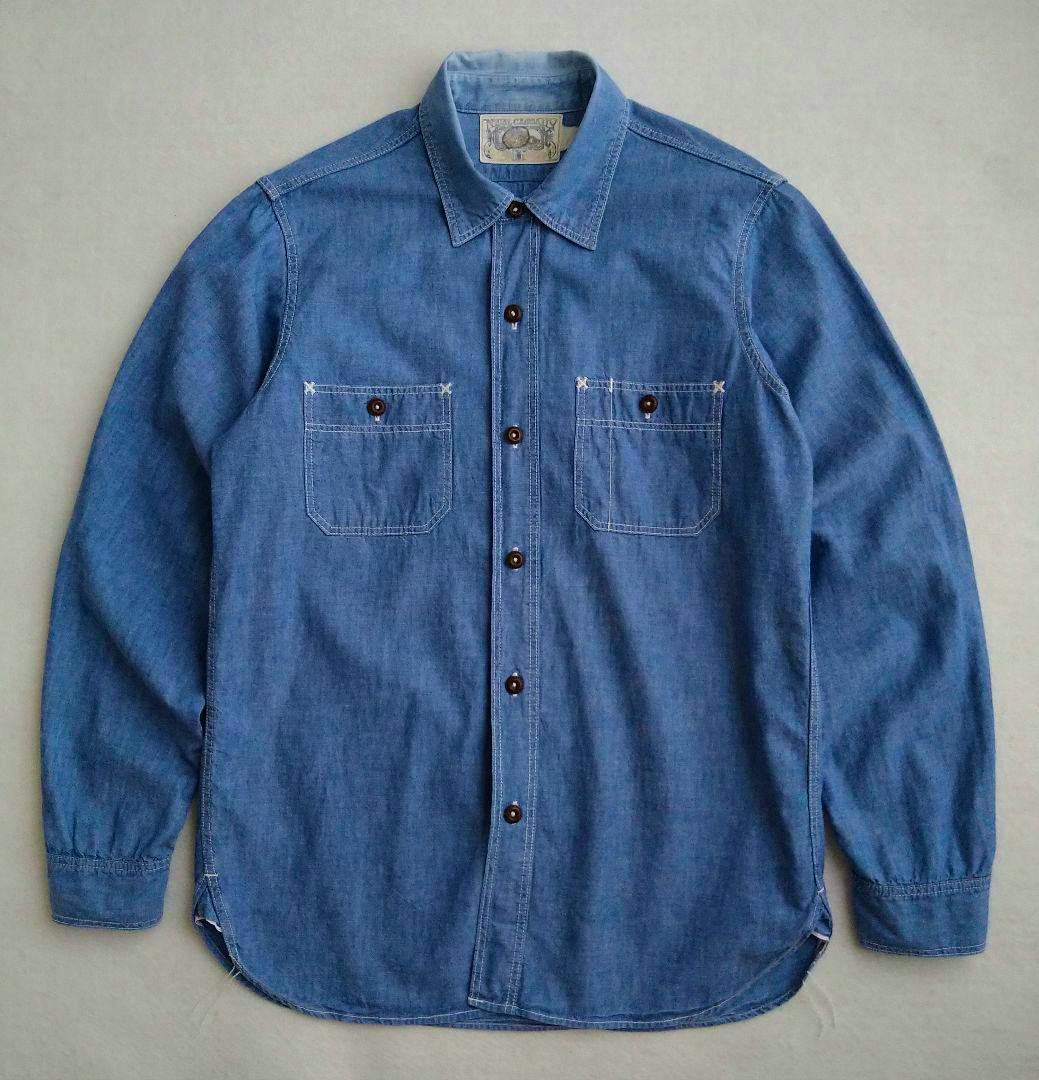 Front view of the men's chambray cotton shirt showing the collar, button placket, and two chest pockets.