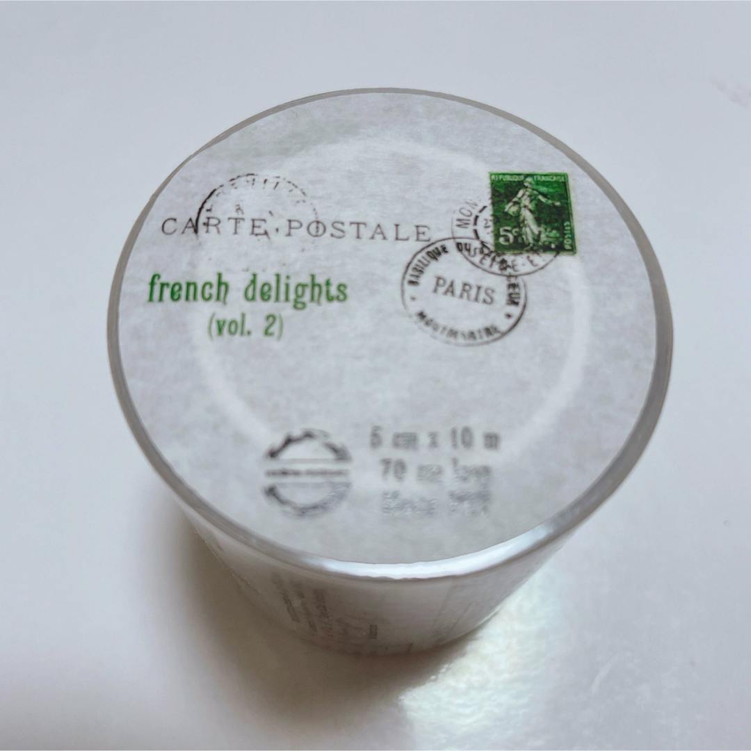 Top view of a roll of masking tape labeled "french delights (vol. 2)" with postal-stamp graphics and size text visible.