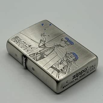 Silver Zippo case engraved with two characters, decorative details, and Zippo branding.