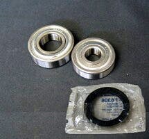 Photo of two front hub bearings and a rubber seal for a Toyota HiAce on a dark surface.