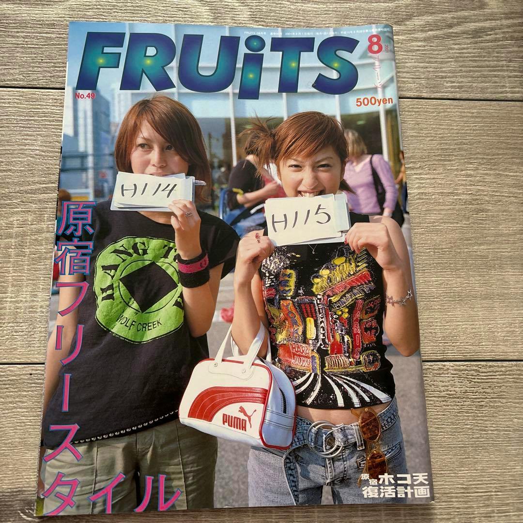 FRUiTS No.49 magazine front cover showing two young women holding handwritten cards and a white-and-red Puma handbag.