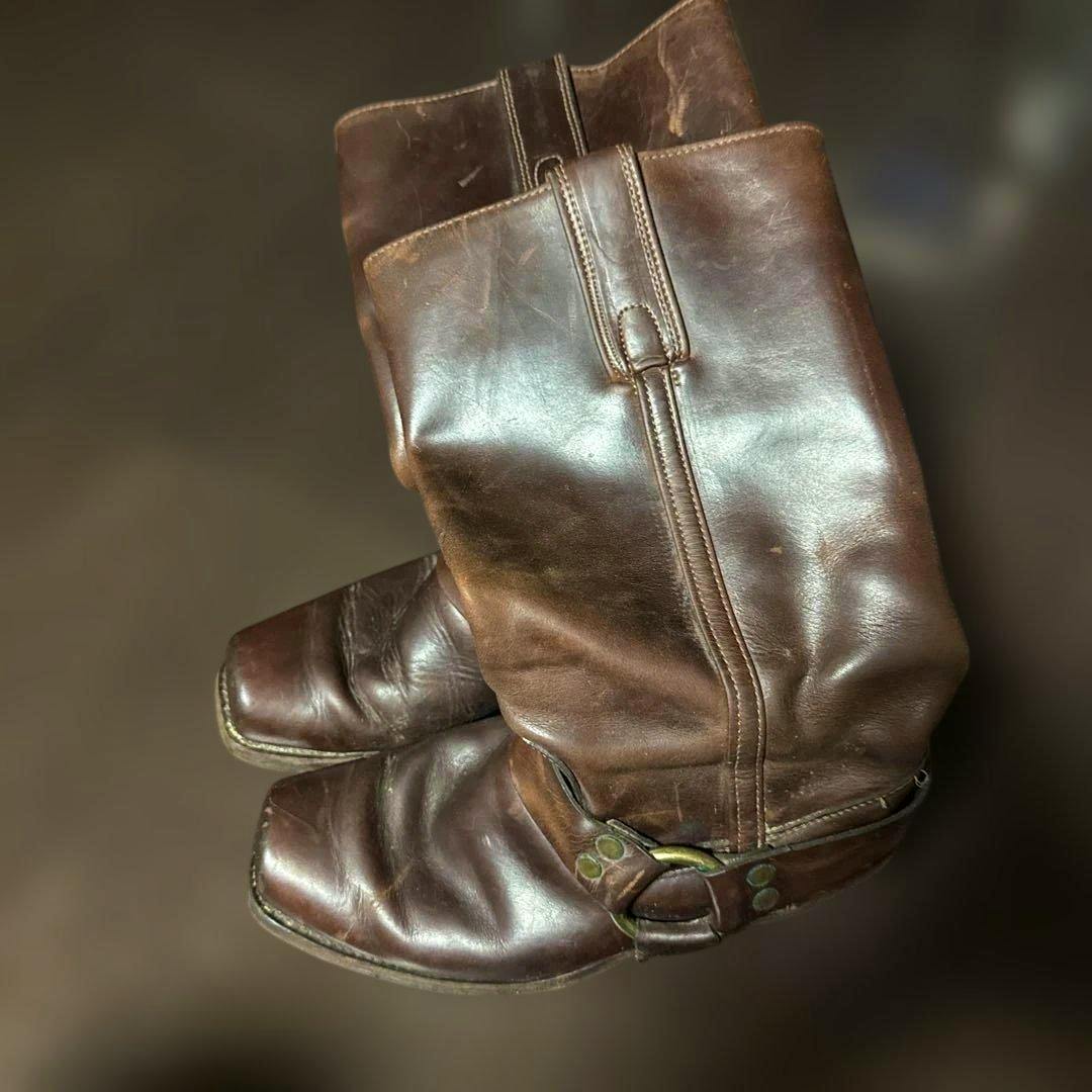 Brown leather FRYE ring boots shown from a top-side angle displaying both boots and the harness detail.