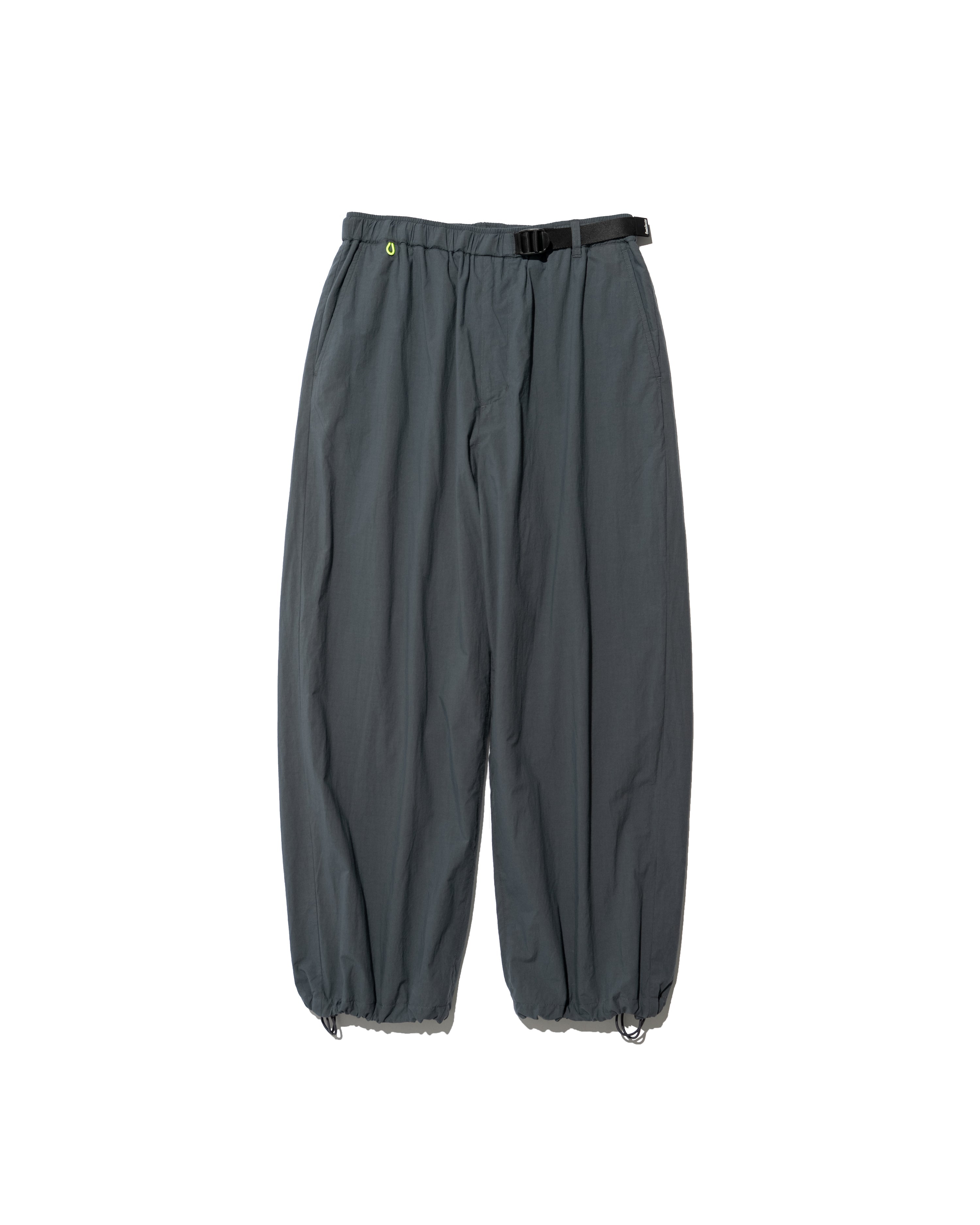 Front view of men's grey cotton climbing pants with a black belt and drawcord hems on a white background.