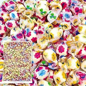 Close-up of many individually wrapped Fujiya Milky white milk candies with colorful printed wrappers and an inset clear bag showing the bulk candies.