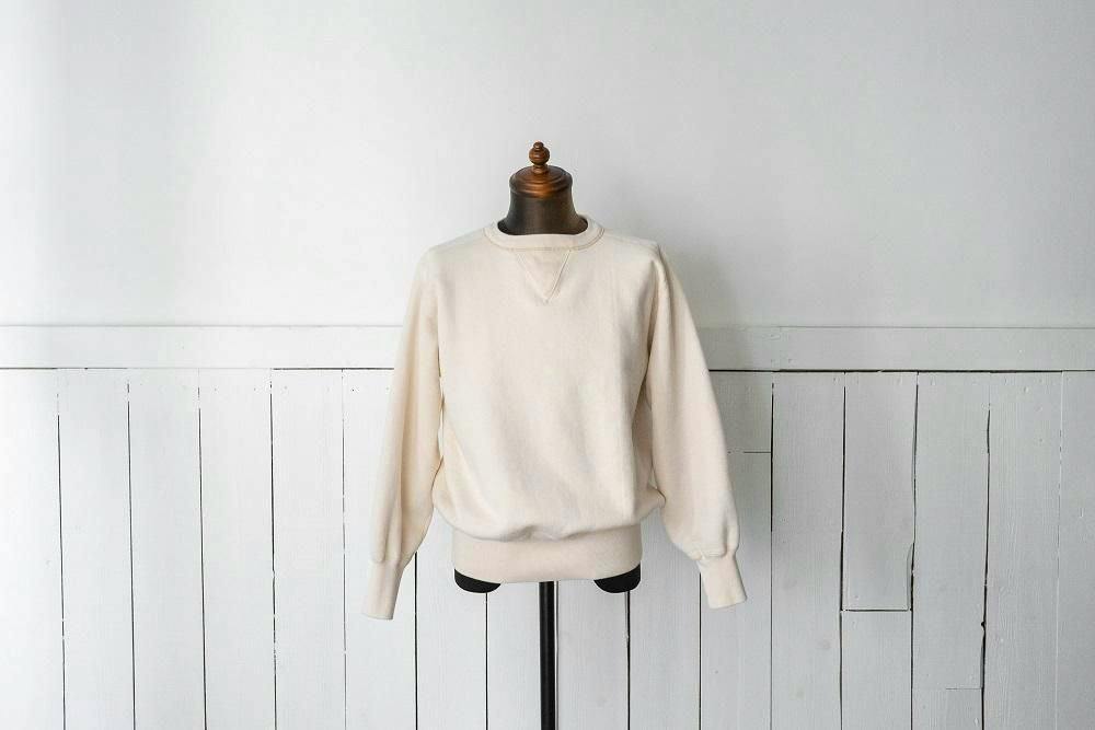 Cream cotton sweatshirt on a dress form showing the front with a double V detail at the neckline.