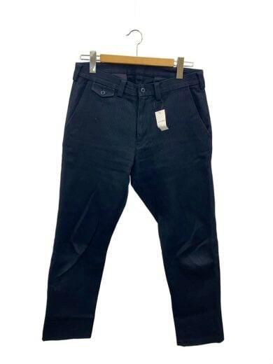 Front view of black corduroy men's pants (size 34) hanging on a wooden hanger with a tag visible.