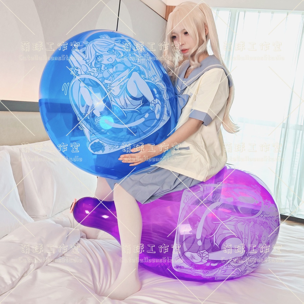A person in a school uniform sits on a purple printed balloon while holding a blue printed balloon, showing the balloon's printed design.