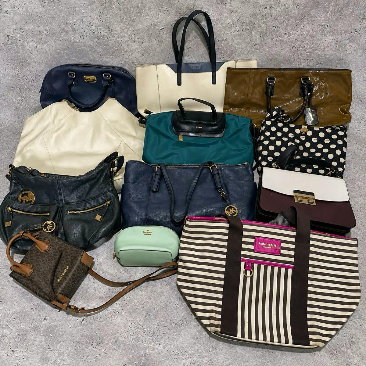 Assorted set of 12 bags and pouches laid out on the floor, photographed from above.