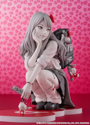 Photograph of the G.S. Collection Gyaru Tomie x Hello Kitty figure crouching on a base against a pink background.