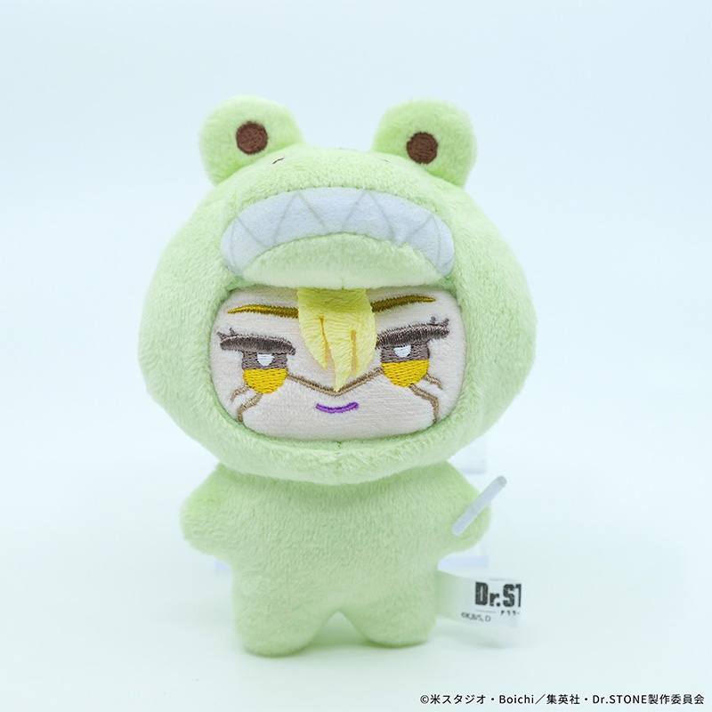 Front view of a green frog-costume plush toy (G.スタンリー・スナイダー variation) on a white background, showing an embroidered face and product tag.