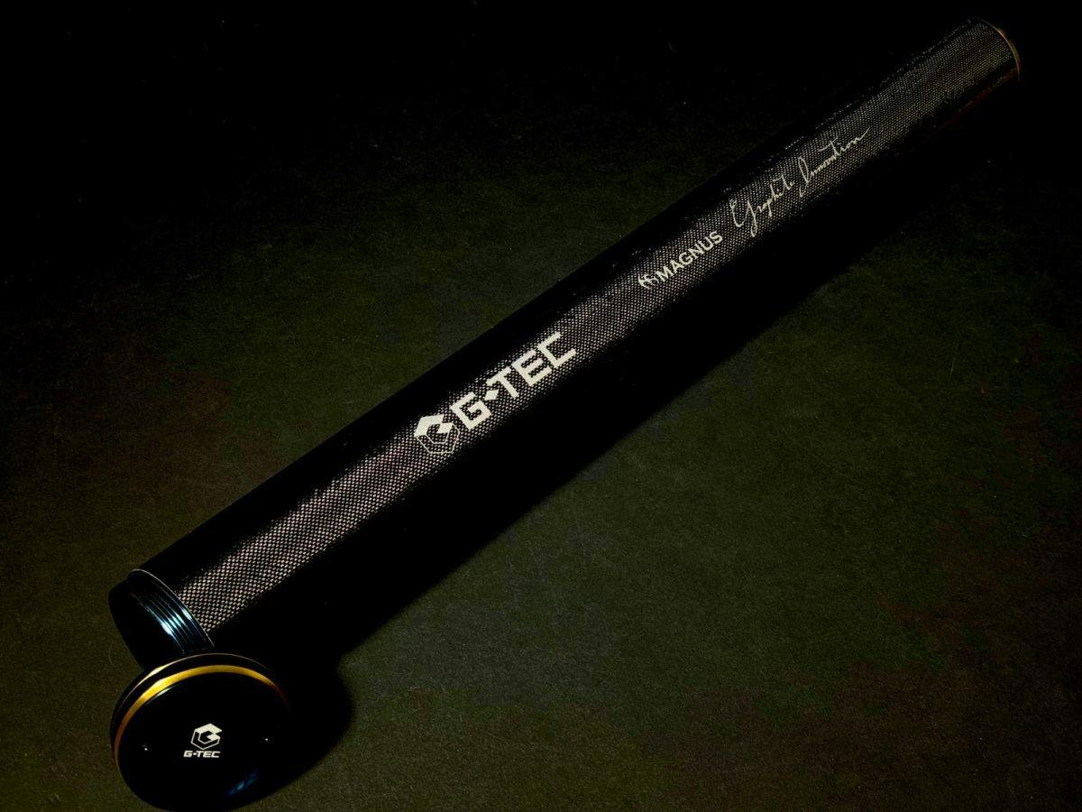 Black carbon rod case with a G-TEC logo and a removable end cap shown on a dark background.