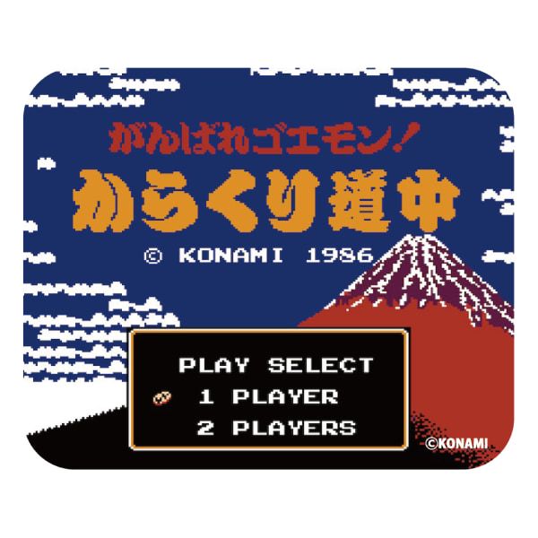 A rectangular mouse pad featuring pixel-art title screen graphics from the Karakuri Douchuu Goemon game, with Japanese title text, KONAMI 1986 credit, a play select box, and a mountain scene.