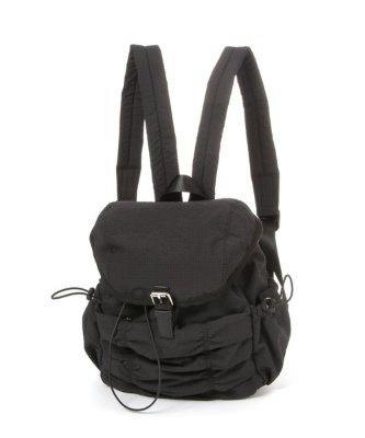 Front view of a black polyester gather-flap daypack backpack showing the flap closure and shoulder straps.