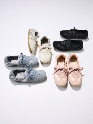 Five pairs of the ballet sneakers arranged on a white background.