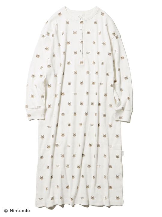 White long-sleeve women's pyjama dress with a short buttoned front and an all-over small repeated face print.