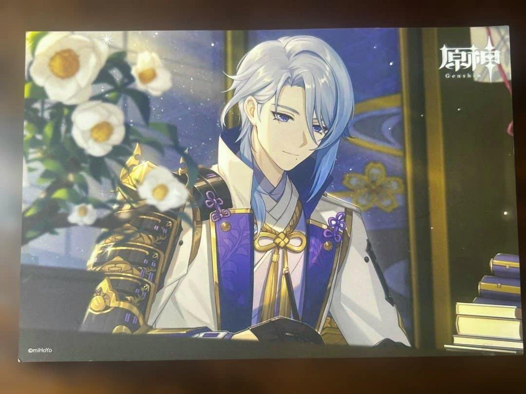 Front of the postcard showing an illustrated portrait of the Genshin character Kamisato Ayato with flowers at left and stacked books at right.