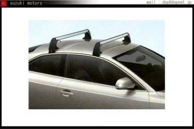 Silver car shown from the side with black roof cross bars installed on the roof.