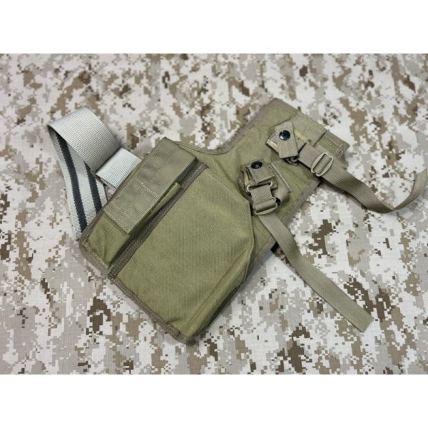 Khaki EAGLE H&K MP7 leg holster shown laid flat on a digital camouflage surface.