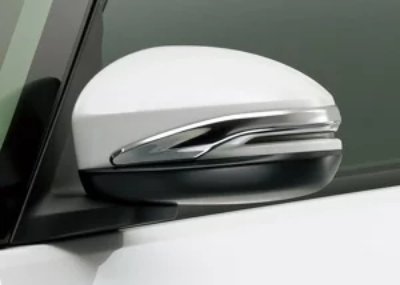 White car side mirror with a chrome door mirror garnish cover installed.