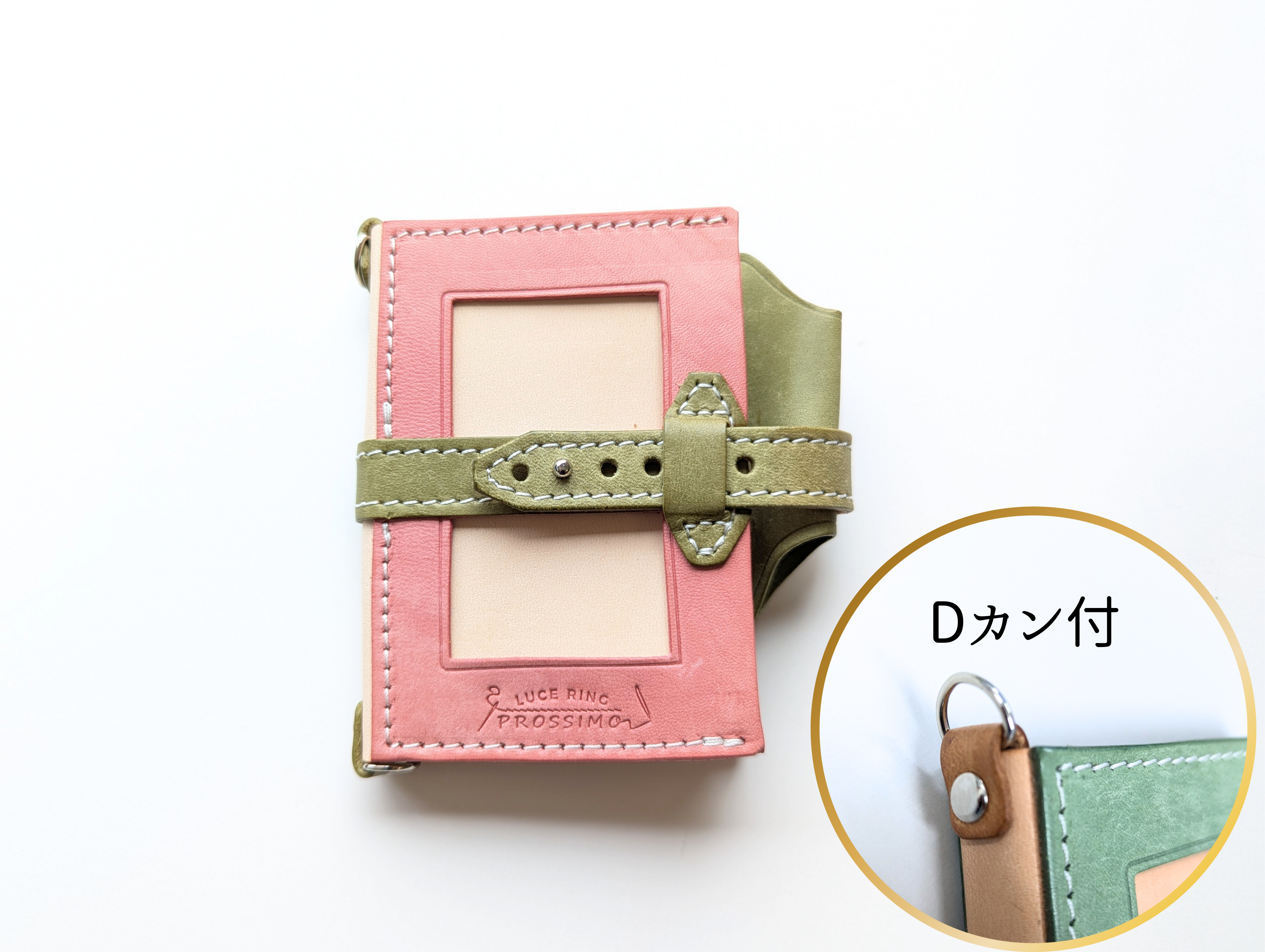Pink leather system notebook with a green strap and visible D-ring, showing a front card window.