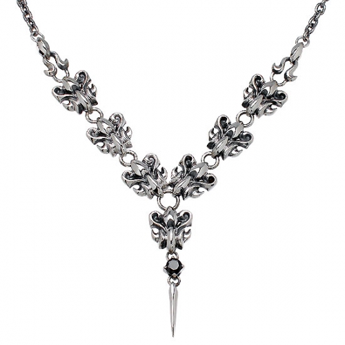 Silver necklace showing linked fleur-like motifs with a central drop spike pendant.