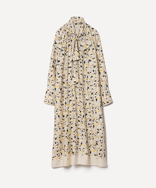 Full-length women's bow-tie dress with a ginkgo leaf print shown against a light background.