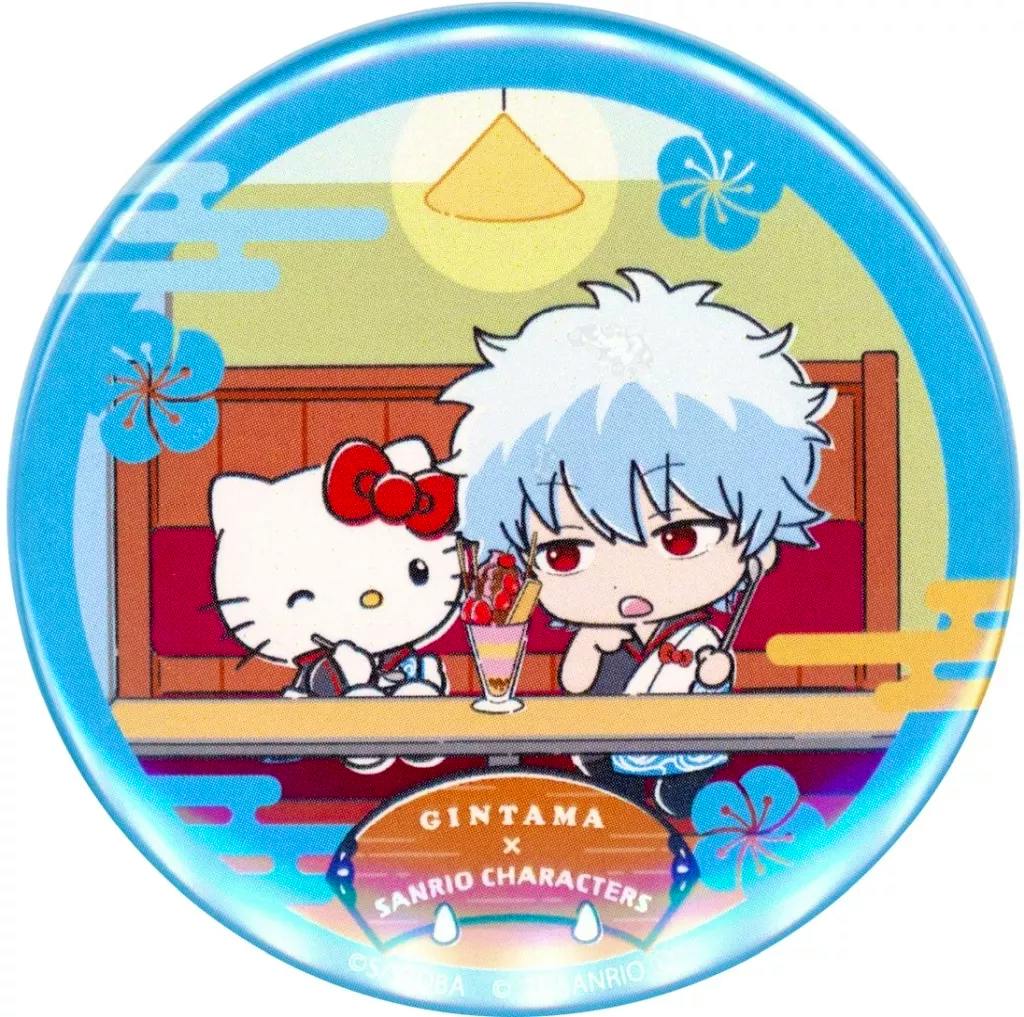 Round can badge showing a chibi illustration of Sakata Gintoki and Hello Kitty sitting at a table with a dessert, labeled GINTAMA x SANRIO CHARACTERS.