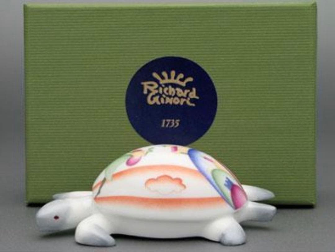 Gio Ponti ceramic turtle (Richard Ginori) figurine with a painted decorative shell displayed in front of a green Richard Ginori box.