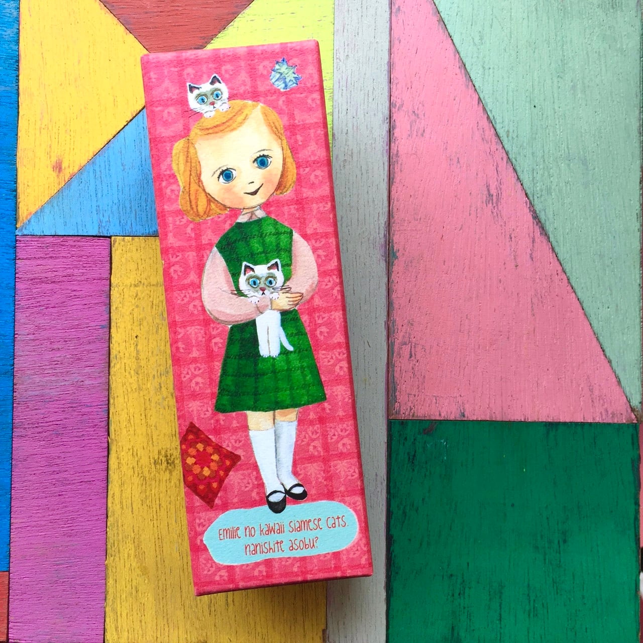 Pink paper storage box showing an illustrated girl holding a cat on the front.