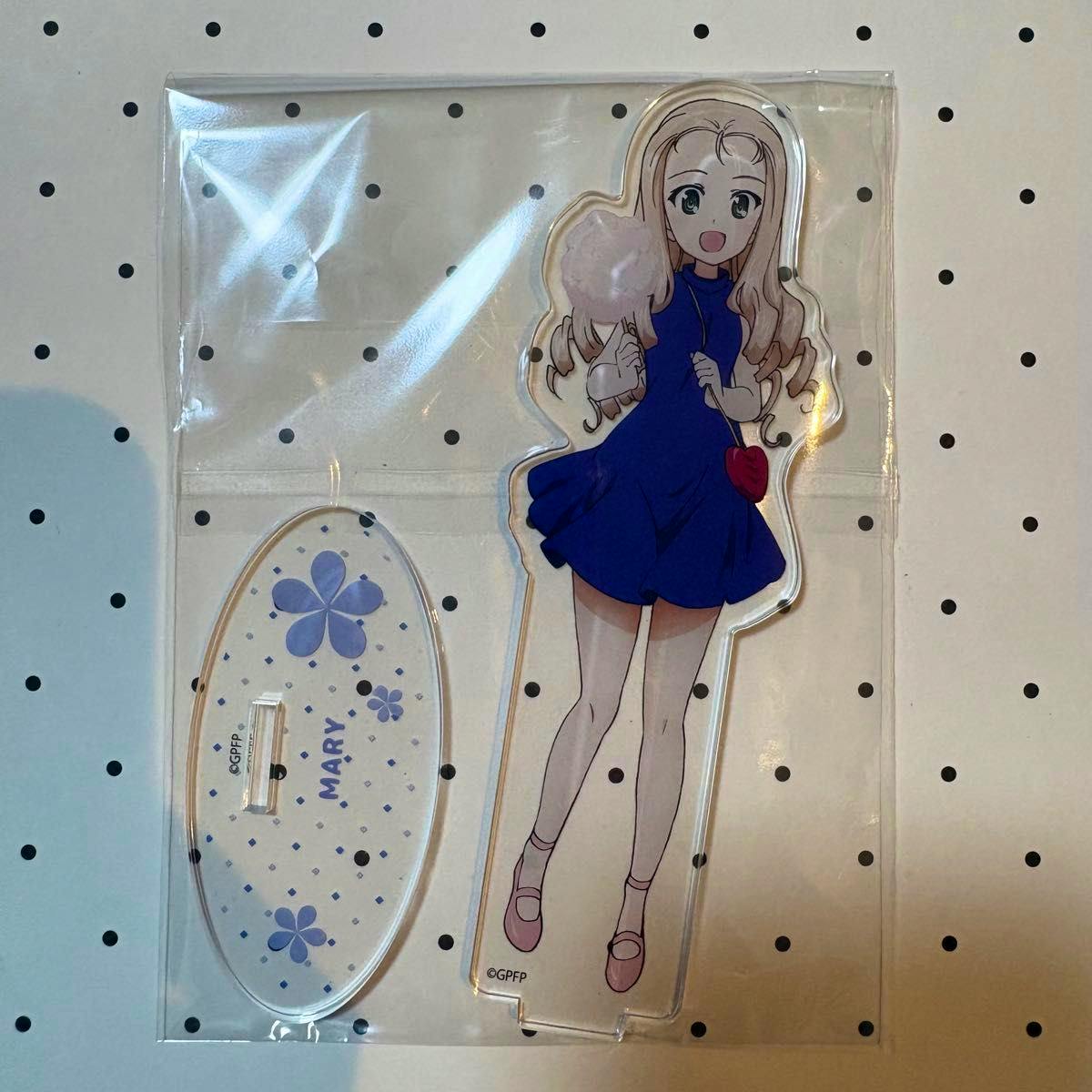 Colored acrylic decorative stand of the character Marie with its oval base shown inside clear plastic packaging.