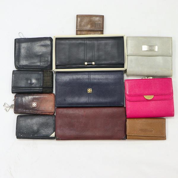 Eleven Givenchy wallets and small leather accessories arranged on a white background.