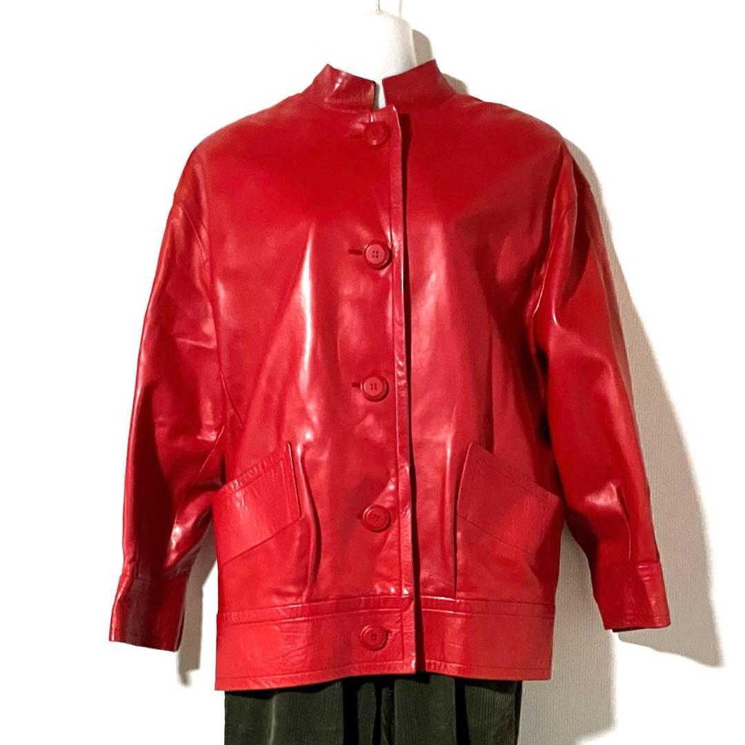 Red vintage men's Givenchy leather jacket with a button-front, stand collar, and front pockets displayed on a mannequin.