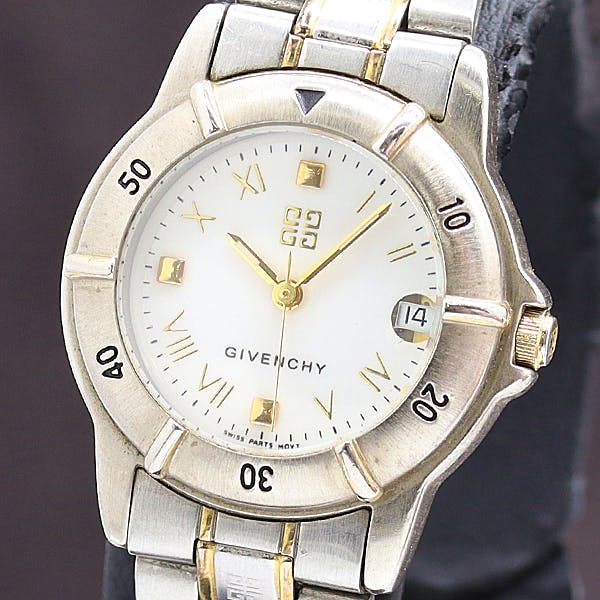 Close-up of a Givenchy ladies' wristwatch with a white dial, gold-tone hands and markers, a date window at 3 o'clock, and a two-tone metal bezel and bracelet.
