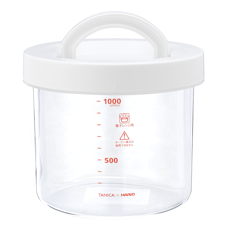 Clear glass jar with a white lid and handle and red measurement markings on the side.