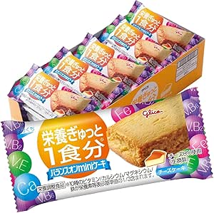 Open box of individually wrapped Balance On mini cheesecake pieces with one wrapped piece displayed in front.