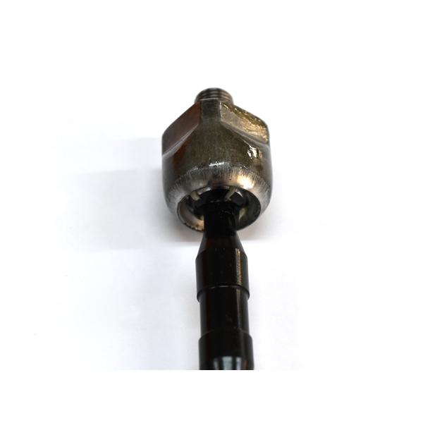 Close-up photo of an automotive steering rack end showing the joint and part of the rod on a white background.