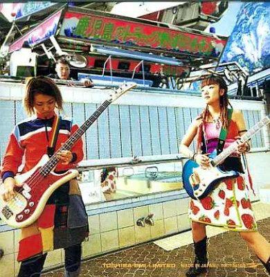 CD cover for GO!GO!7188 showing two people holding electric guitars standing in front of a colorful fairground ride.