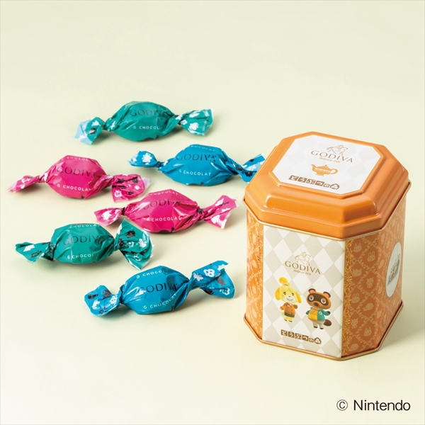 A GODIVA Animal Crossing decorative tin with six individually wrapped chocolates displayed beside it.