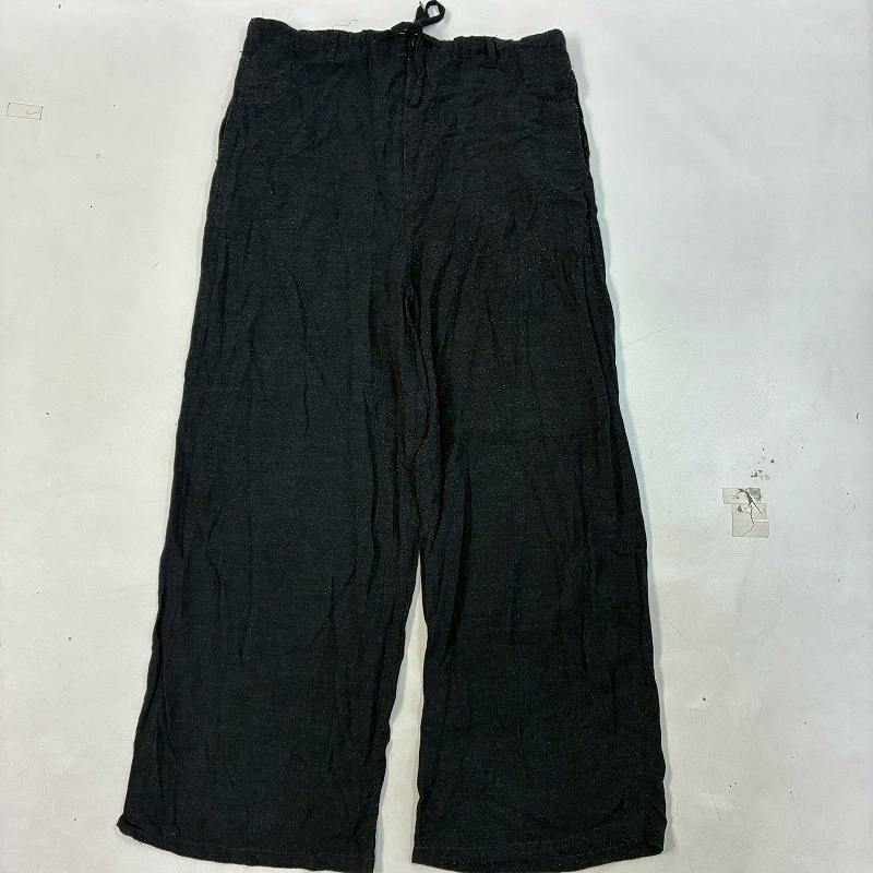 Dark gray women's wide wool pants laid flat on a white background.
