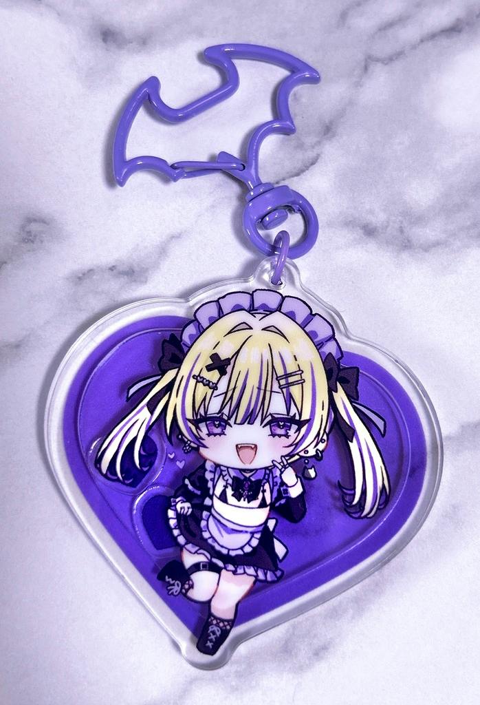 A purple heart-shaped acrylic keychain showing a chibi gothic maid character with a purple bat-shaped clasp.