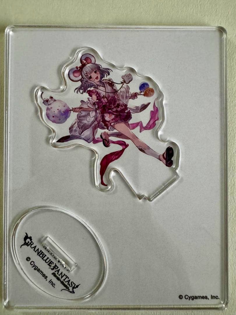 Clear acrylic decorative stand showing the character artwork and its separate oval GRANBLUE FANTASY base on a light background.