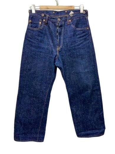 Front view of indigo men's Heritage Straight Fit cotton jeans hanging on a wooden hanger.