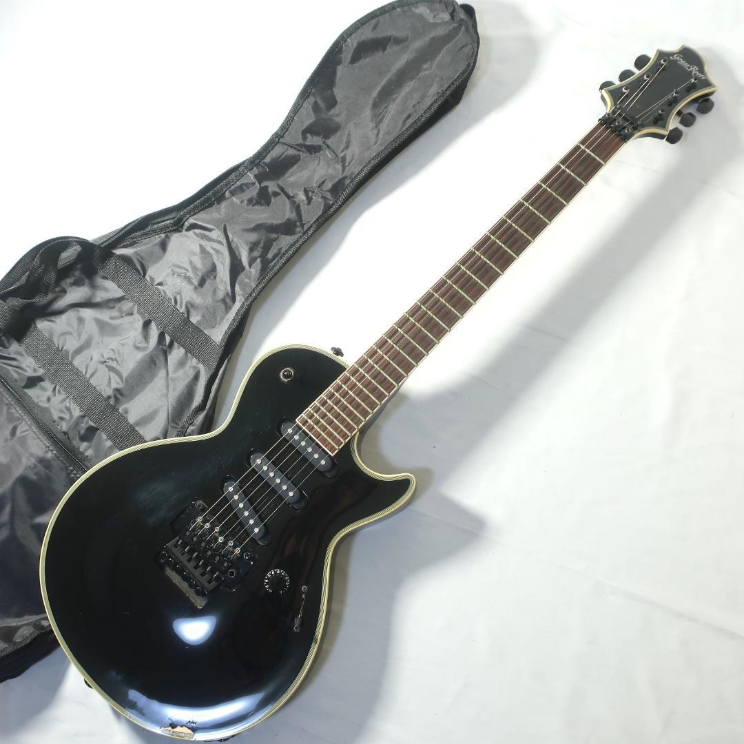 A black GrassRoots SUGIZO model electric guitar shown with its soft case on a white background.