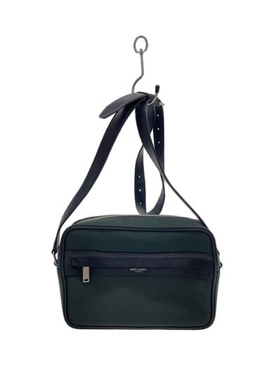 Green cow leather shoulder bag with a front zip pocket and an adjustable strap hanging from a hook.